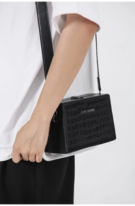 Side view of black faux crocodile leather box bag with embossed Gone Knows logo