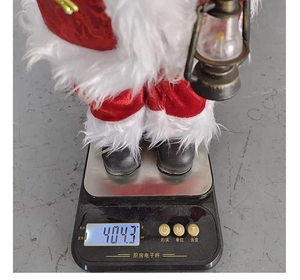 Standing Santa Claus doll weighing 404.3g on an electronic scale for weight measurement