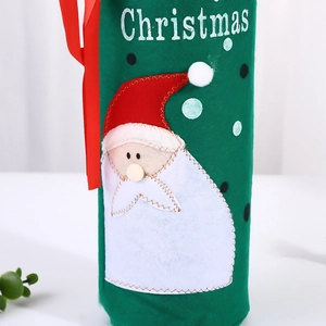 Detail of Christmas wine bottle cover with felt fabric, sequined Santa Claus, and red ribbons