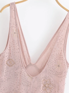 Detail of pink sequins and beads on V-neck mesh midi dress hanging on wooden hanger
