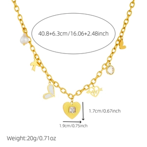 Gold layered necklace with rhinestone heart, shell and pearl charms on white background