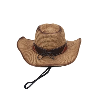 Detail of a brown woven straw cowboy hat with a leather decorative band and wind strap