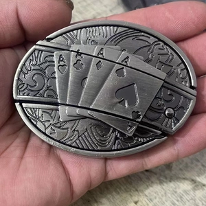 Detailed close-up of antique silver belt buckle featuring embossed poker ace cards