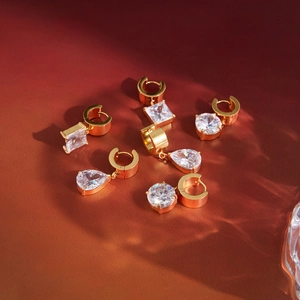 Macro detail of 18K gold plated stainless steel hoops with sparkling geometric zircons