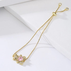 Adjustable gold bracelet with cubic zirconia bear pendant and pink heart stone