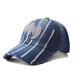 Detail of silver rhinestones and sequins on dark blue denim baseball cap surface