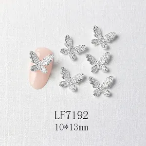 Macro detail of 3D silver butterfly nail charms with micro-rhinestones and size 10x13mm