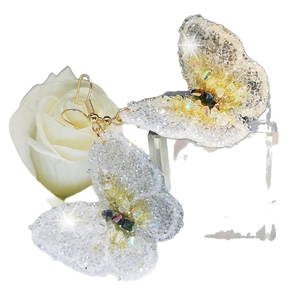 Handcrafted crystal butterfly drop earrings with shimmering beaded texture and golden hooks