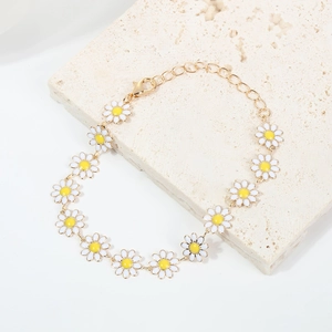 Bracelet chaîne dorée minimaliste avec breloques marguerites en émail blanc et jaune