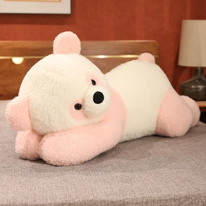 Détail de la peau d'ours panda en peluche rose et blanc sur un lit douillet