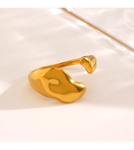 Macro shot of polished gold irregular lava ring with smooth liquid texture surface