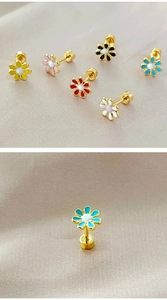 Macro view of tiny daisy stud earrings in six colors on champagne silk fabric