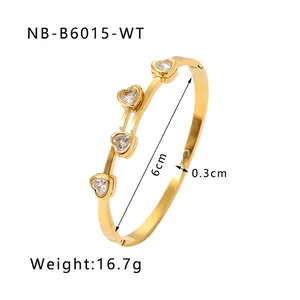 Detail showing 6cm inner diameter of gold heart bangle with colorful cubic zirconia