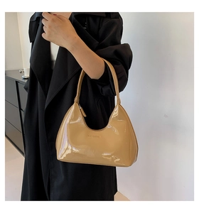 Detail of beige crescent hobo bag in glossy patent leather with GULT GALOAD logo