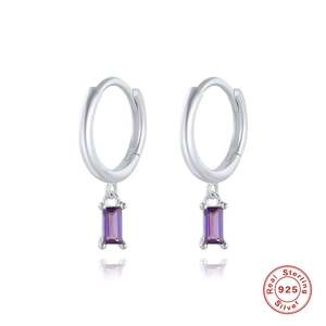 Macro shot of 925 sterling silver hoop earrings with rectangular purple gemstone detail