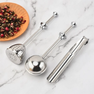 Three assorted 304 stainless steel tea infusers including ball and pipe shapes on marble