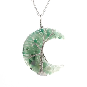 Detail of moon-shaped pendant with life tree wire wrap and green natural crystals