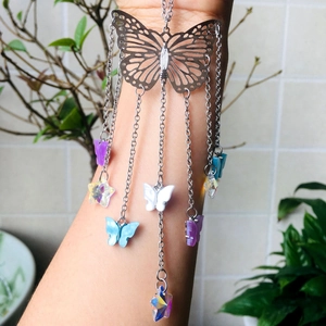 Macro view of crystal butterfly suncatcher with colorful pendants for garden decor