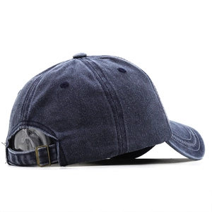 Detail view of washed denim baseball cap with adjustable antique bronze metal buckle