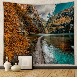 Detail view of sunset mountain landscape tapestry hanging in a cozy home interior