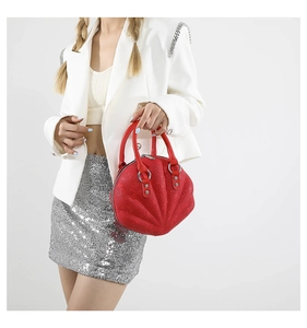Detail of red embossed shell handbag with silver hardware and star pattern texture