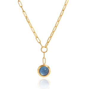 Close-up of golden horseshoe necklace featuring a blue gemstone on paperclip chain