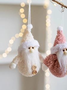 Close-up of soft plush Christmas gnome ornaments with white long beard and wooden buttons