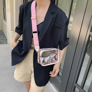 Detailed shot of transparent PVC crossbody bag featuring a pink adjustable wide strap