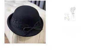 Detailed view of black wool dome hat featuring delicate lace trim and ribbon bow