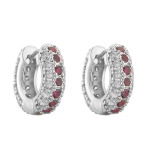 Macro detail of silver hoop earrings featuring pavé-set red and white zircon stones