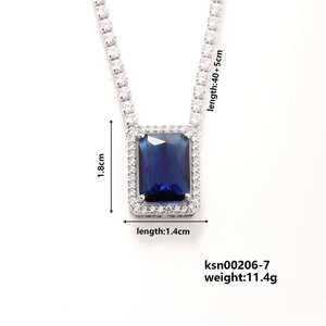 Detail showing sapphire blue rectangular pendant with diamond border on silver tennis chain