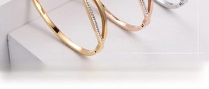 Detail of elegant butterfly ceramic bracelets with gold finish and inlaid rhinestones