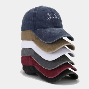 Detailed stack of vintage washed cotton baseball caps with a cute cat face embroidery