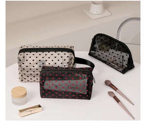 Close-up of mesh makeup bags with flocked heart patterns and cosmetic accessories