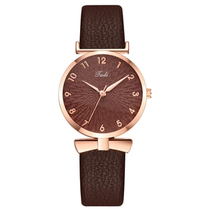 Women's rose gold quartz watch with brown leather strap and bow detail on the lugs
