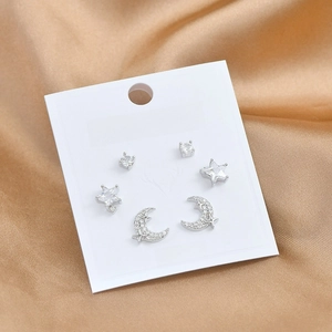 Detail view of S925 silver moon and star stud earring set on white display card