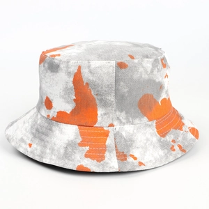 Detailed view of tie-dye bucket hat with gray and orange patterns and reinforced stitching