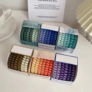 Set of six colorful spiral hair ties in gradient tones for no-trace hair styling