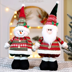 Close-up of plush Christmas snowman and Santa with striped hats and wood button details