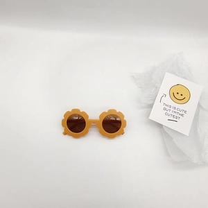 Yellow flower-shaped kids sunglasses with retro matte finish and decorative card