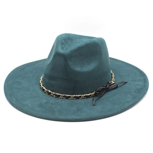 Detailed view of teal blue faux suede fedora with gold chain and bow decoration
