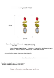 Macro detail of tiered oval crystal drop earrings in red, yellow, green, and blue