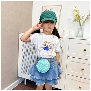 Detail of mint green quilted mini crossbody bag with gold chain for toddler girl fashion