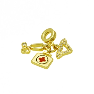 Detailed view of medical charms with golden stethoscope, first aid box and crystals