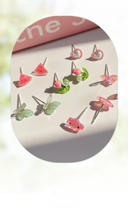 Detail of cute stud earring set featuring floral, butterfly, and heart resin designs