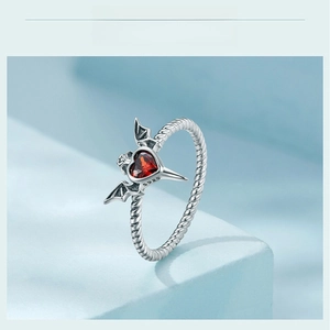 Detailed close-up of S925 silver ring with red heart stone and bat wing texture