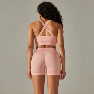 Rear view of seamless knit yoga set featuring criss-cross sports bra and high-waisted shorts