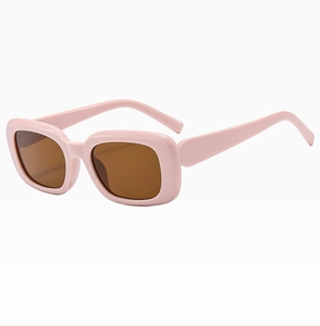 Detailed view of pink thick square frames and brown lenses on retro sunglasses
