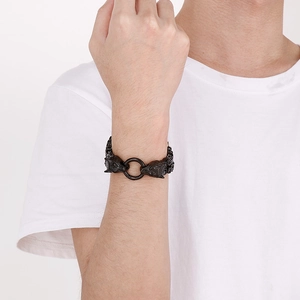 Close-up of black wolf head bracelet with heavy link chain worn on male wrist