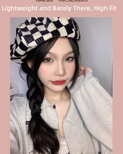 Close-up of a stylish black and white checkered beret with textured pleated fabric on model